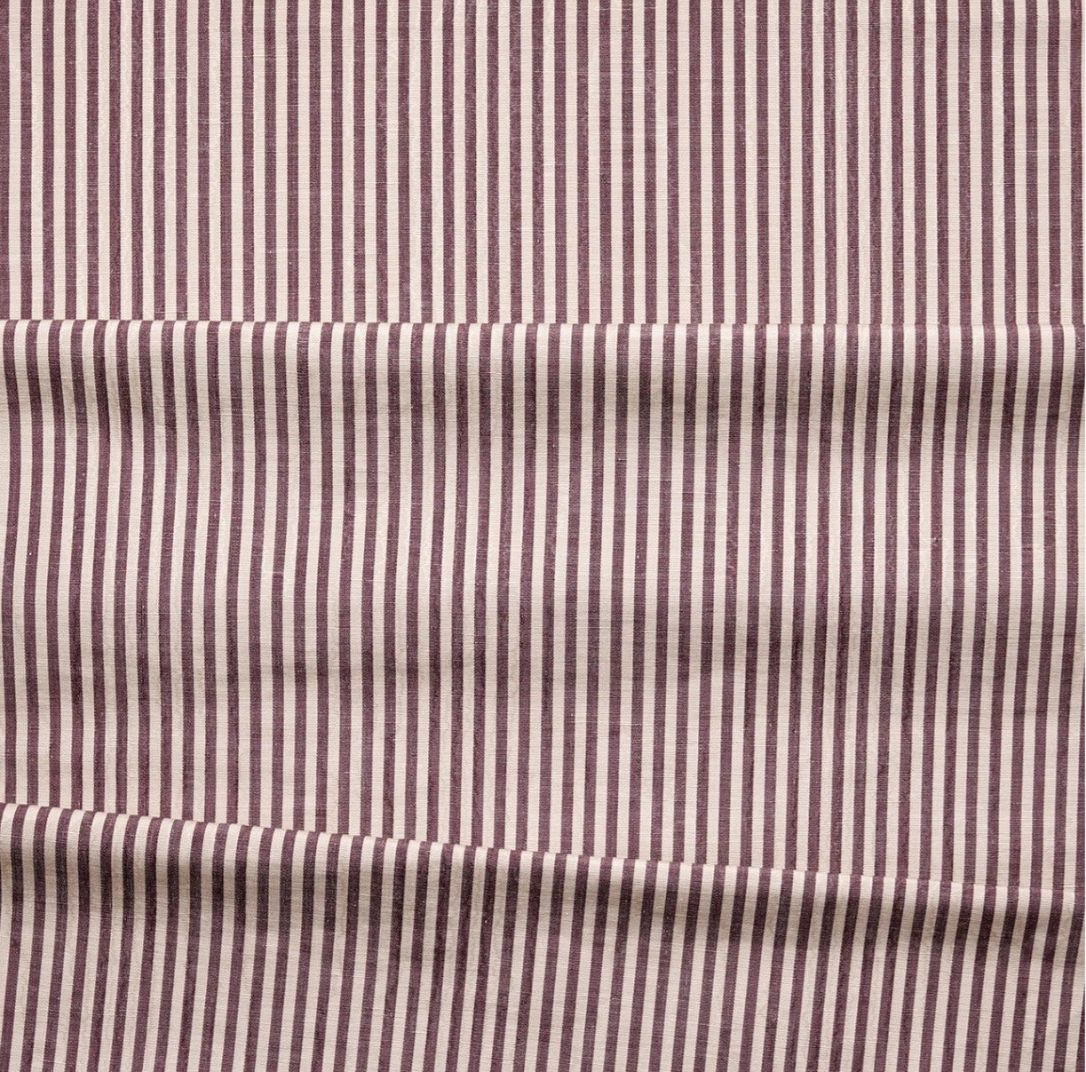 Close-up of fabric with plum and white vertical stripes