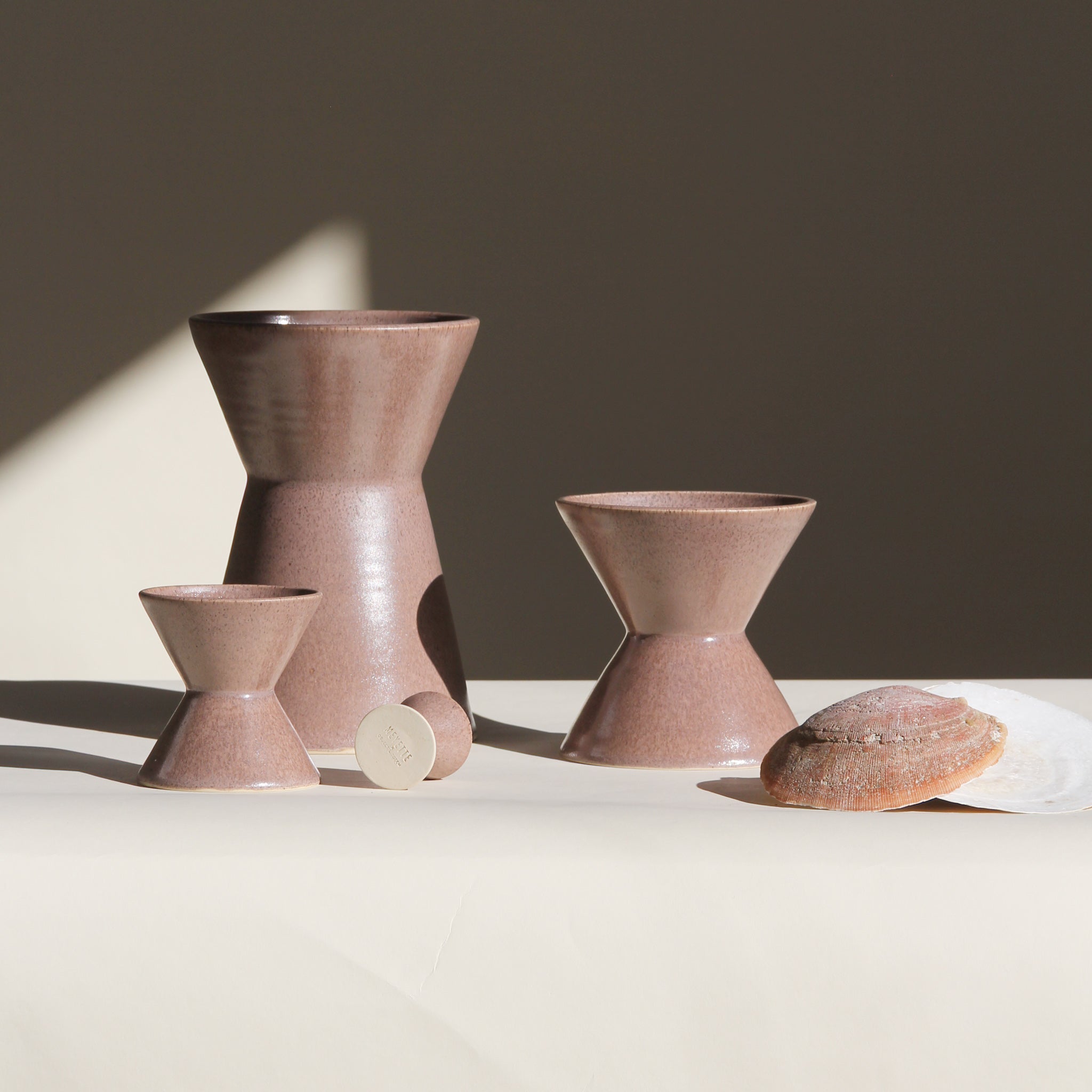 Set of ceramic vessels on a neutral background