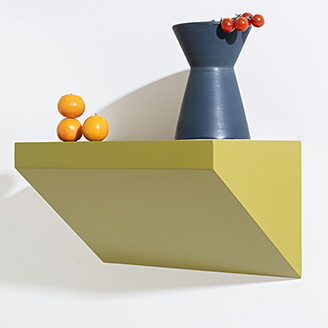Geometric shelf with a blue vase and fruit on a white background