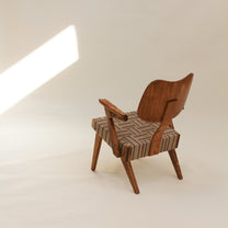 Wooden chair with a woven webbing seat on a plain background