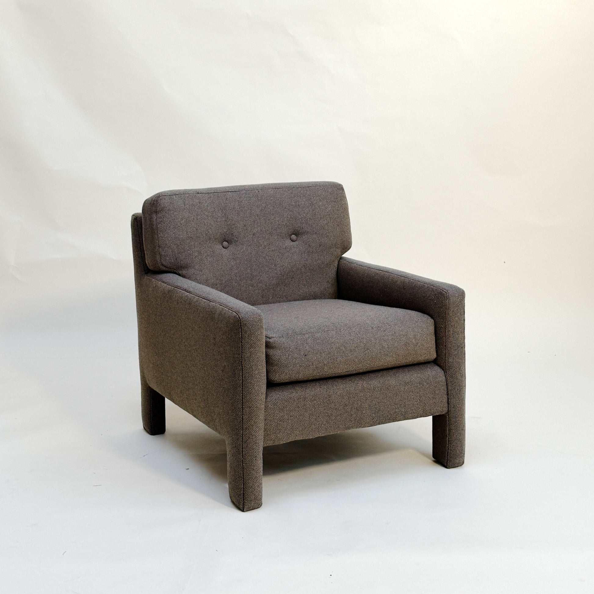 Gray Parsons style armchair on a white background