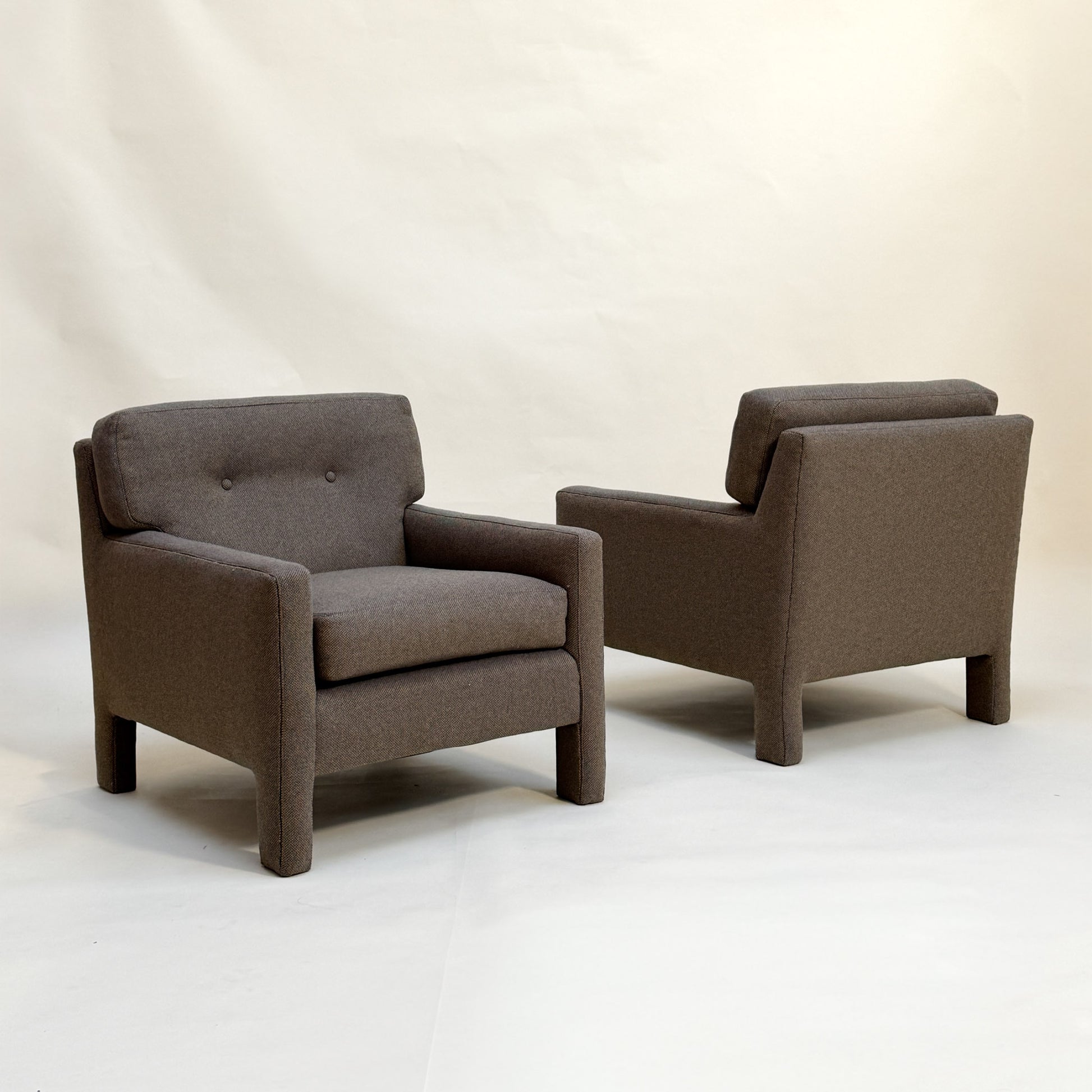 Two micro-checked Designtex fabric armchairs on a white background