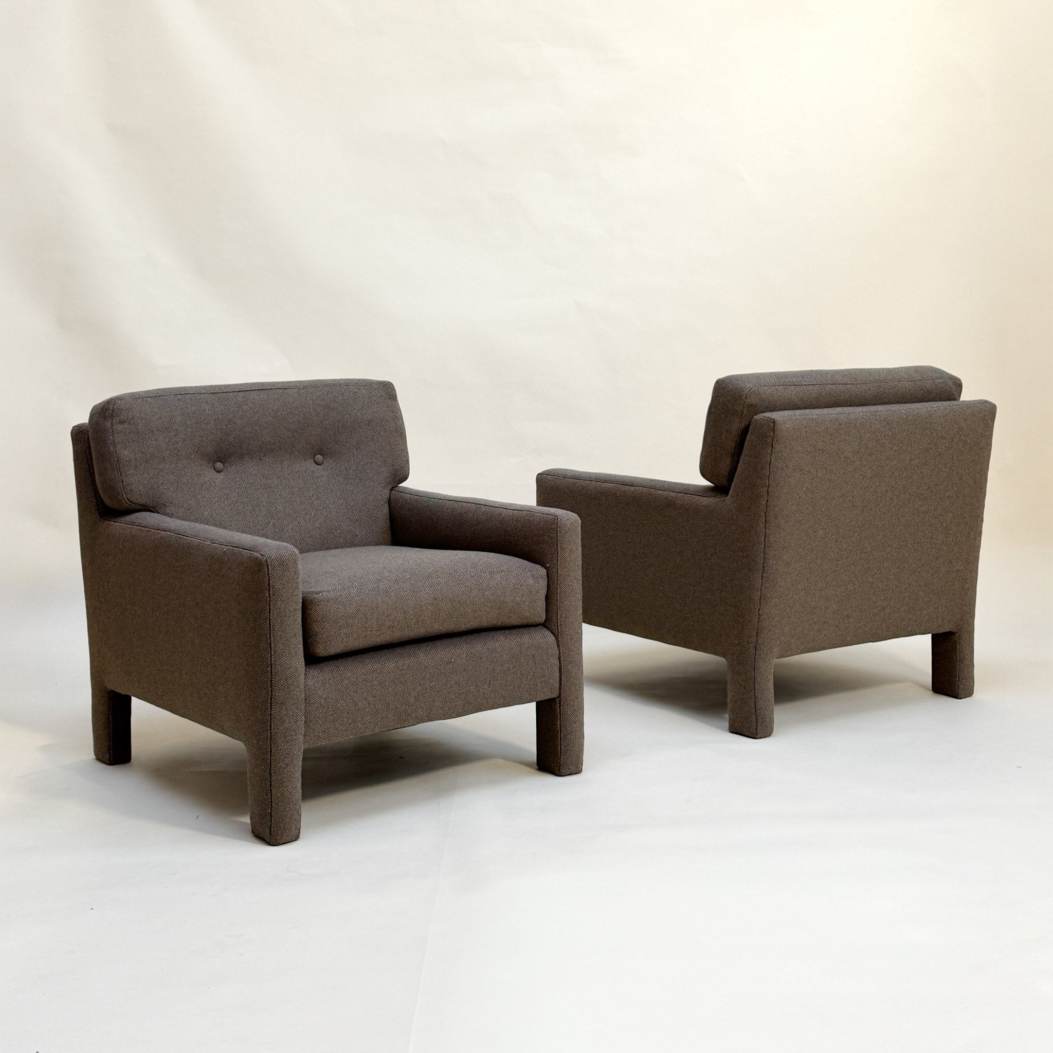 Two micro-checked Designtex fabric armchairs on a white background
