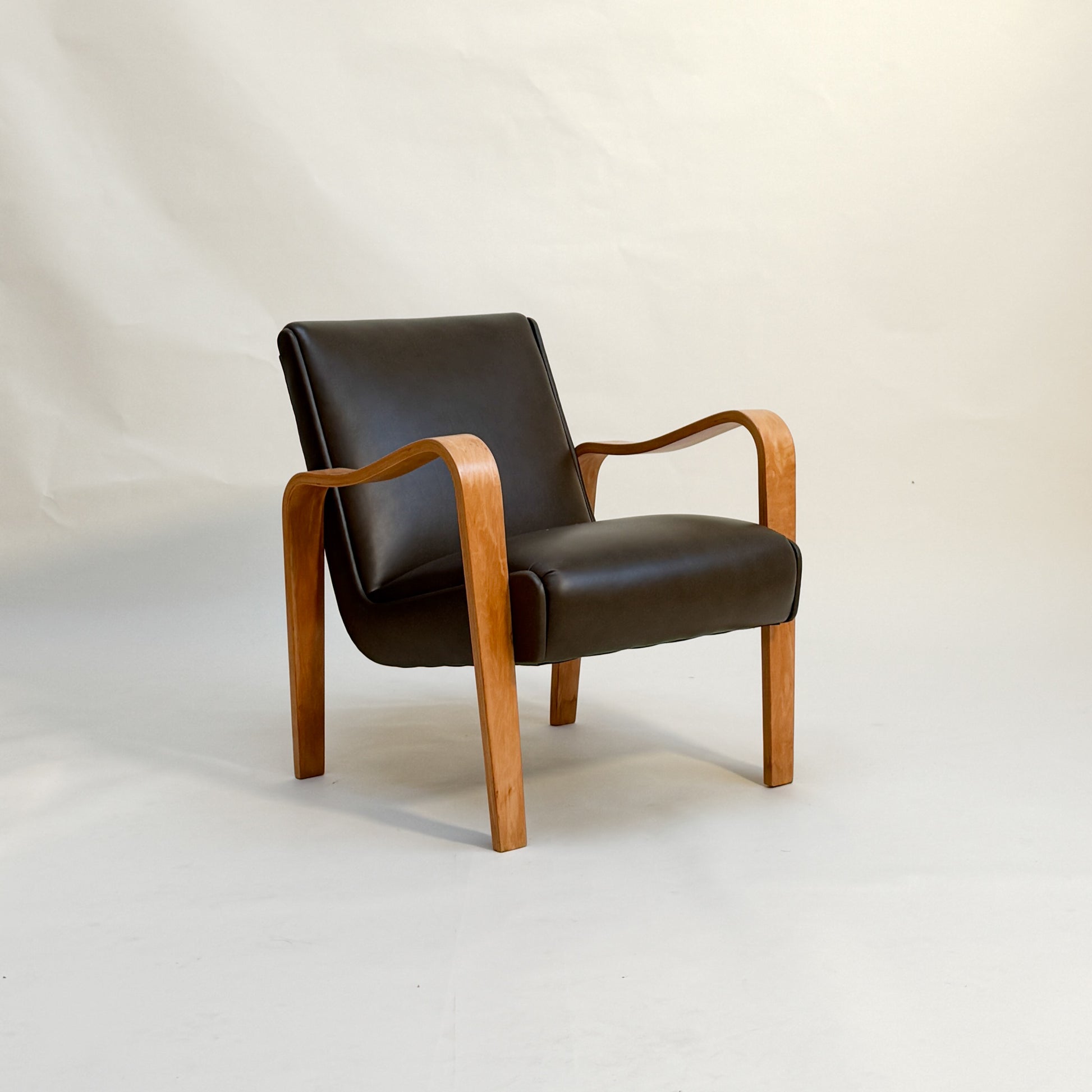 Chair with an olive leather seat and backrest on a white background