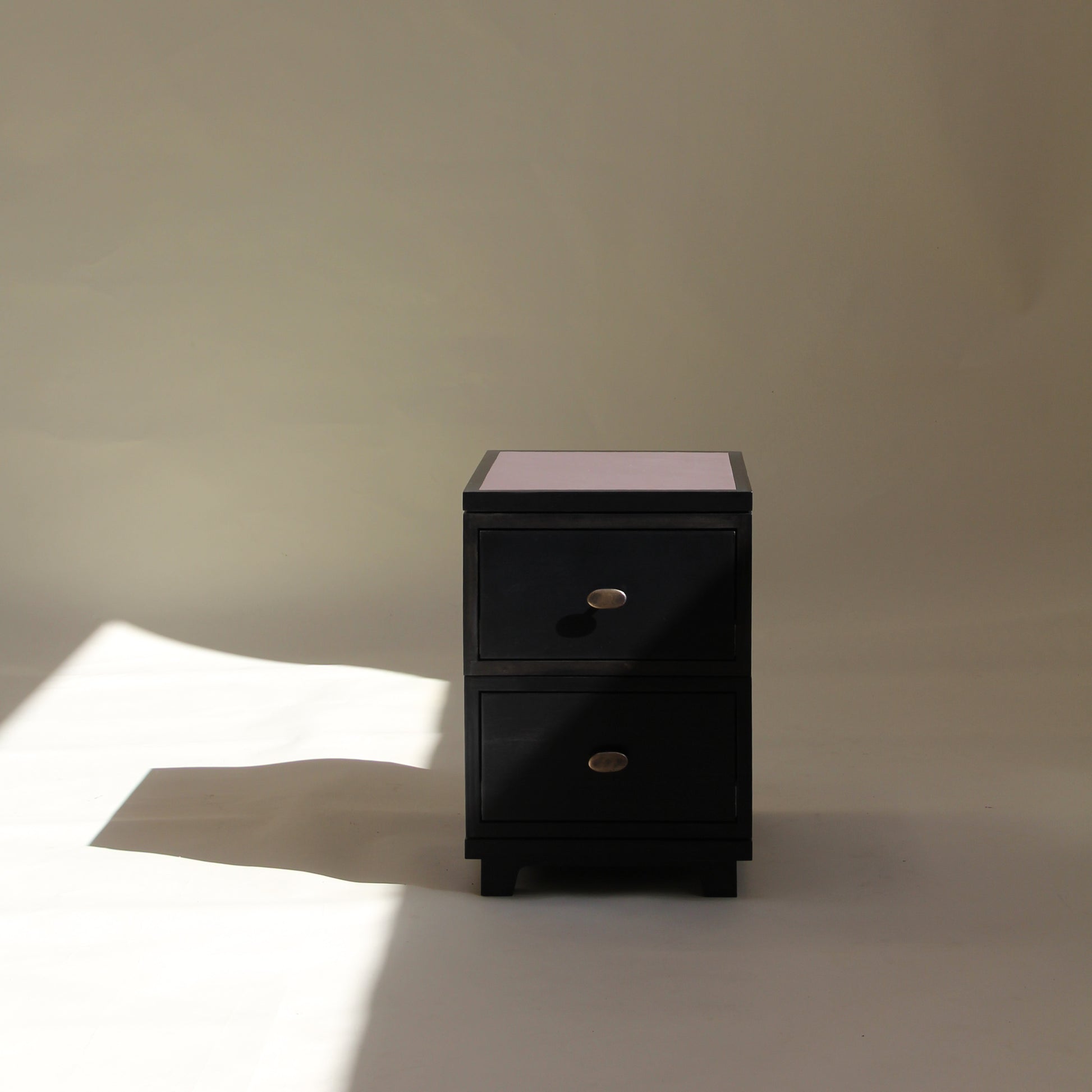 Black two drawer on a beige background