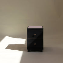 Black two drawer on a beige background