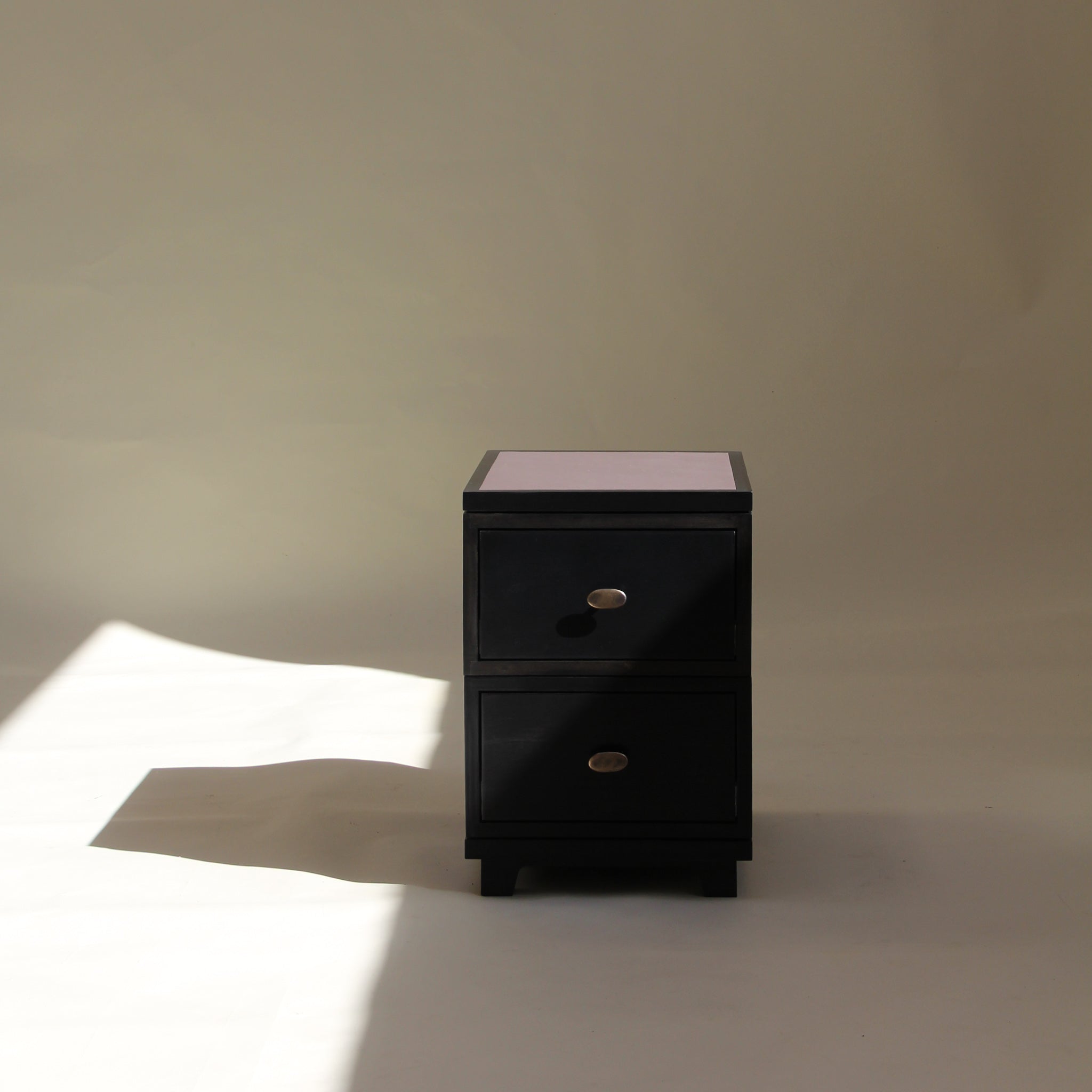 Black two drawer on a beige background
