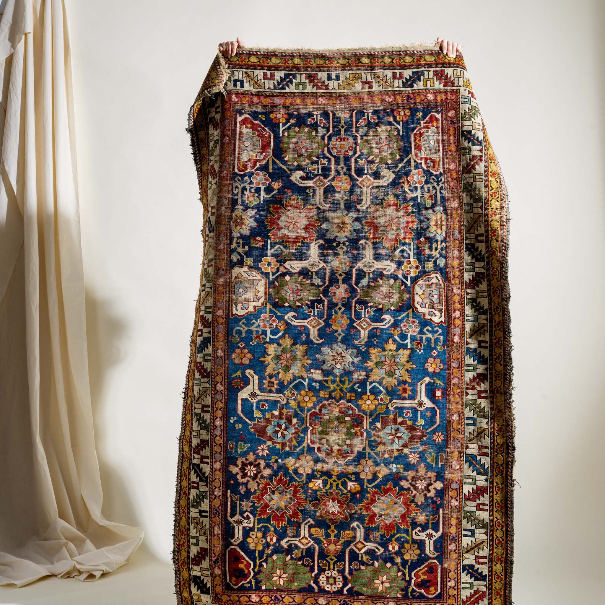 Decorative rug with intricate patterns on a white background