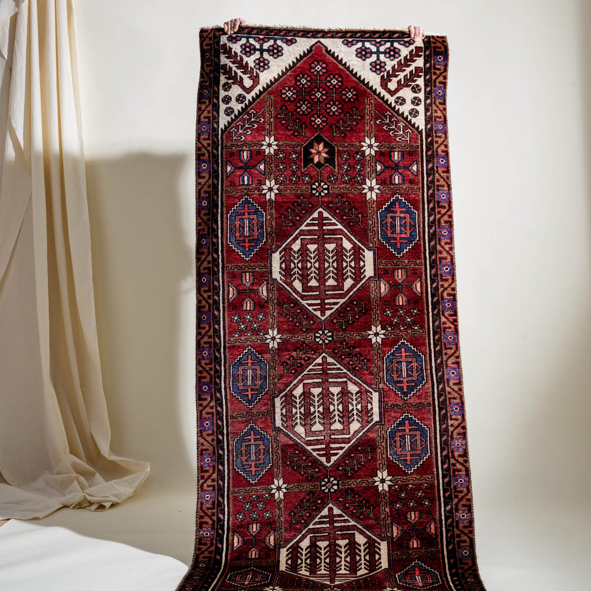 Decorative vintage rug with intricate patterns on a white background