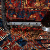 Close-up of a textured rug with a measuring tape laid across it