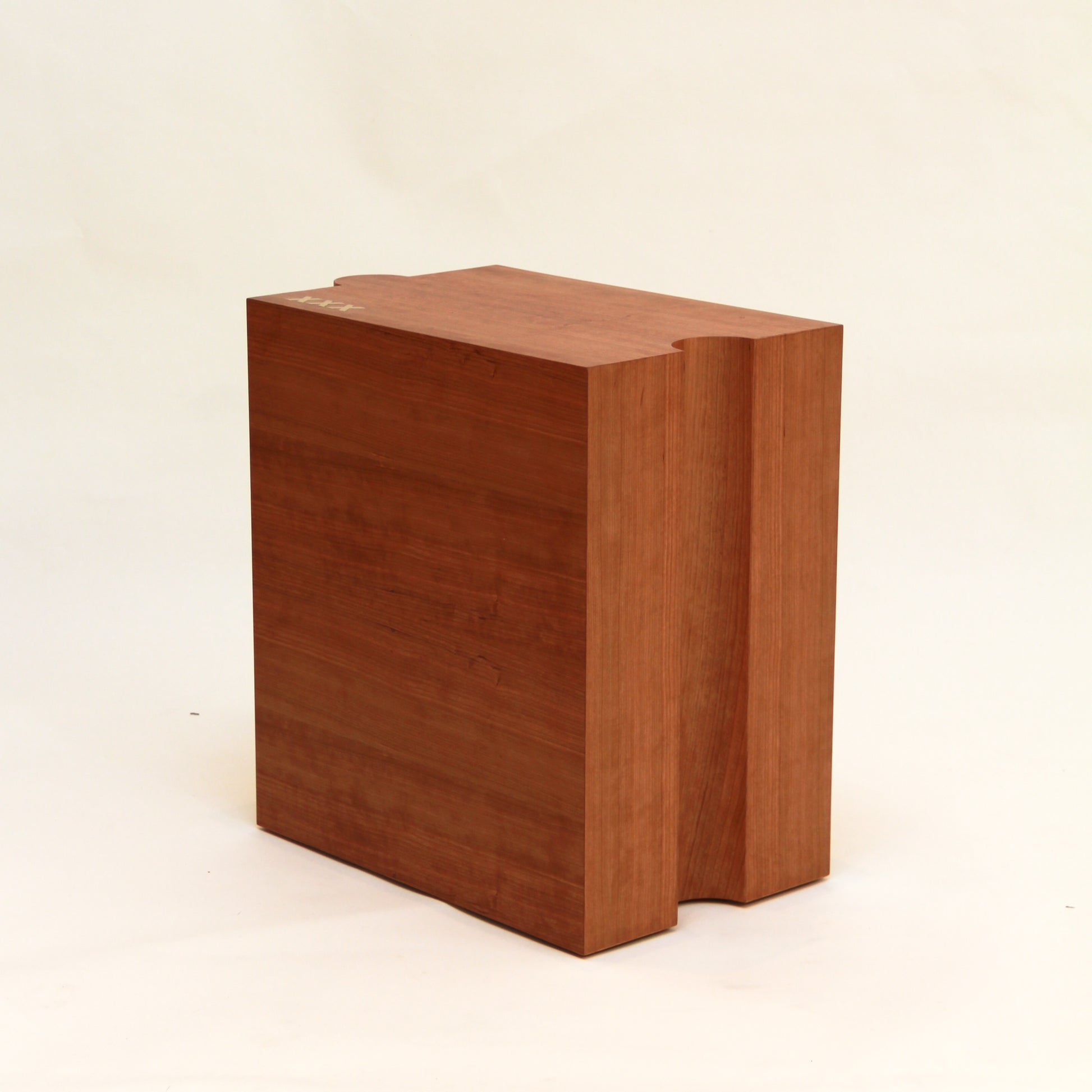 Wooden handcrafted side table on a beige background