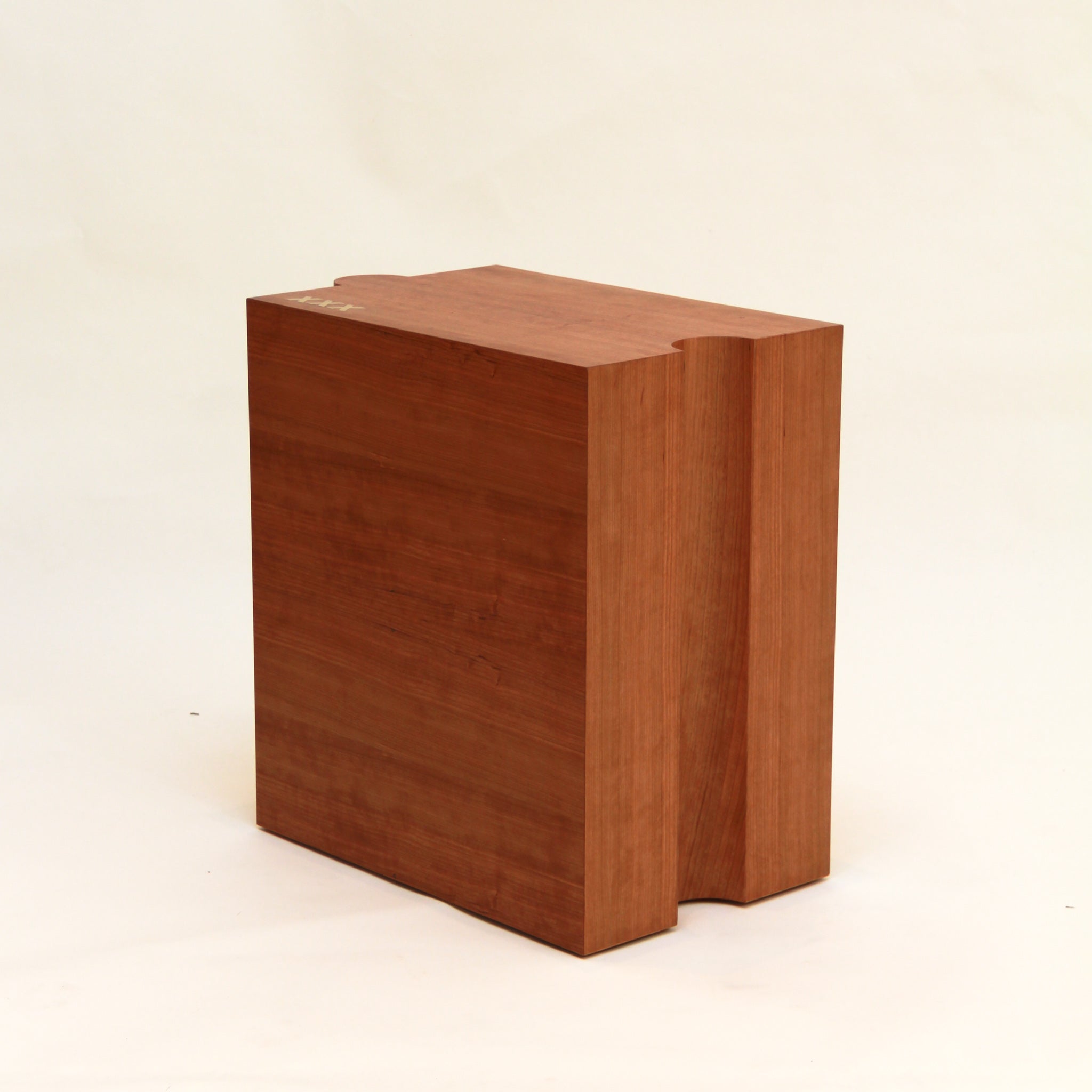 Wooden handcrafted side table on a beige background