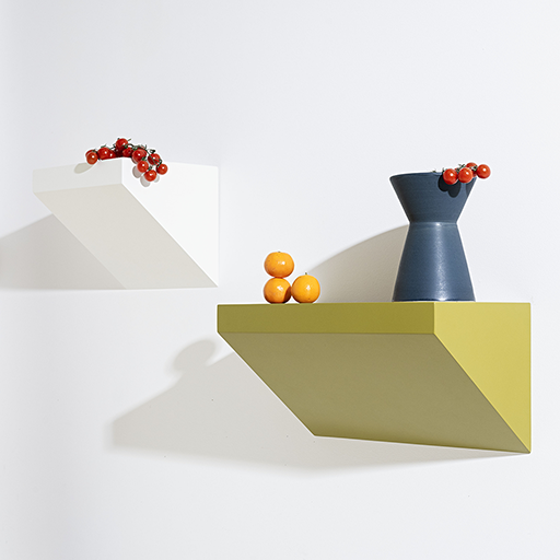 Geometric wall shelves with decorative items on a white background