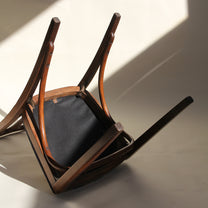 Underside of wooden chair on a light background