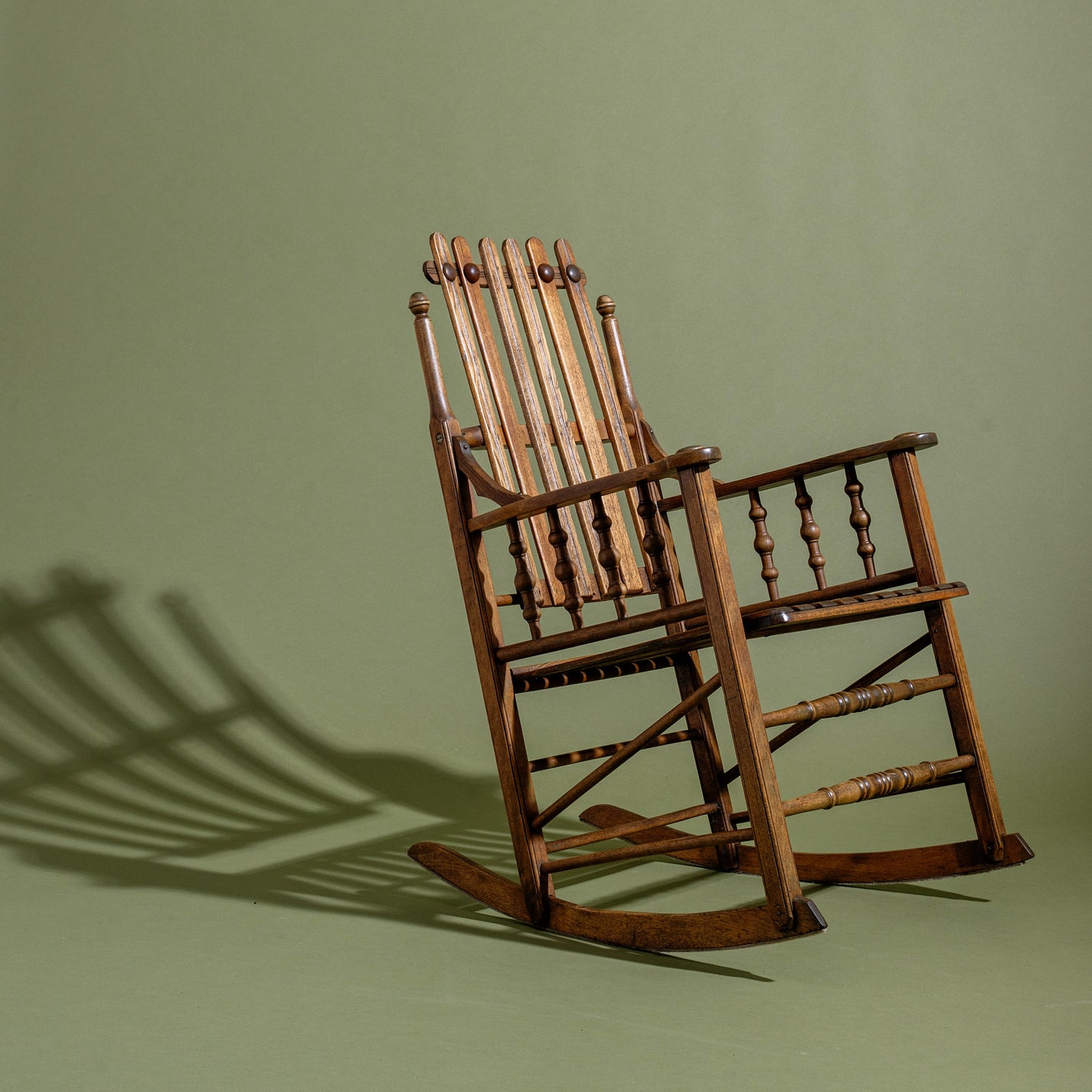 Wooden rocking chair on a green background
