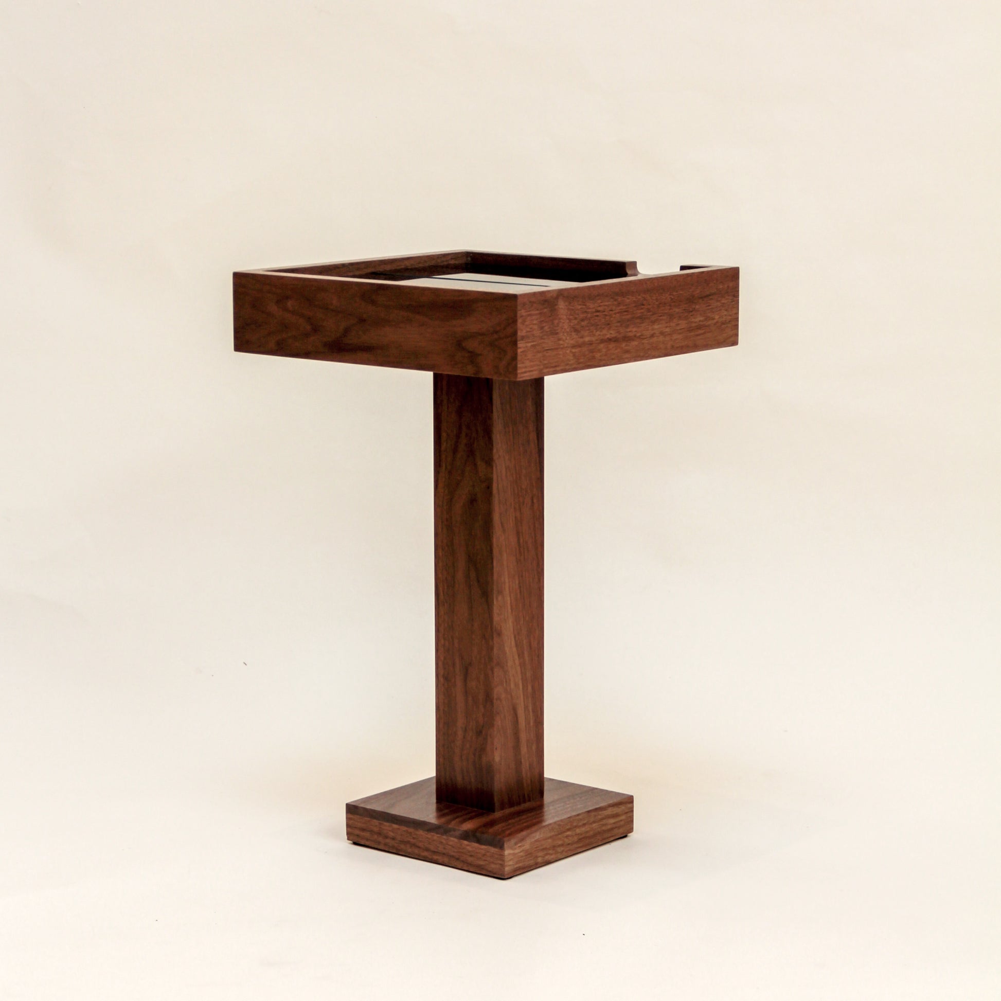 Wooden side table with a rectangular top on a beige background