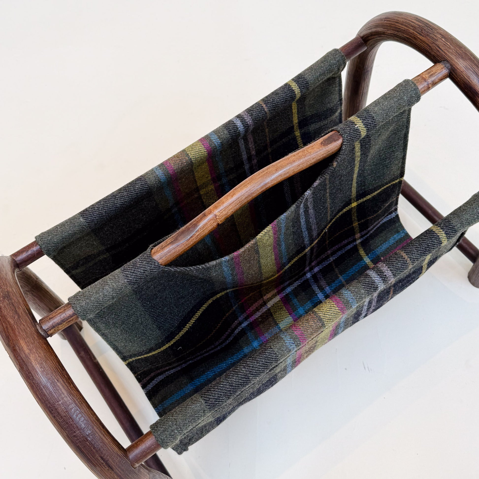 Woven magazine rack with a plaid pattern on a white background