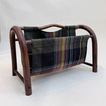 Wooden magazine rack with plaid fabric cover on a white background