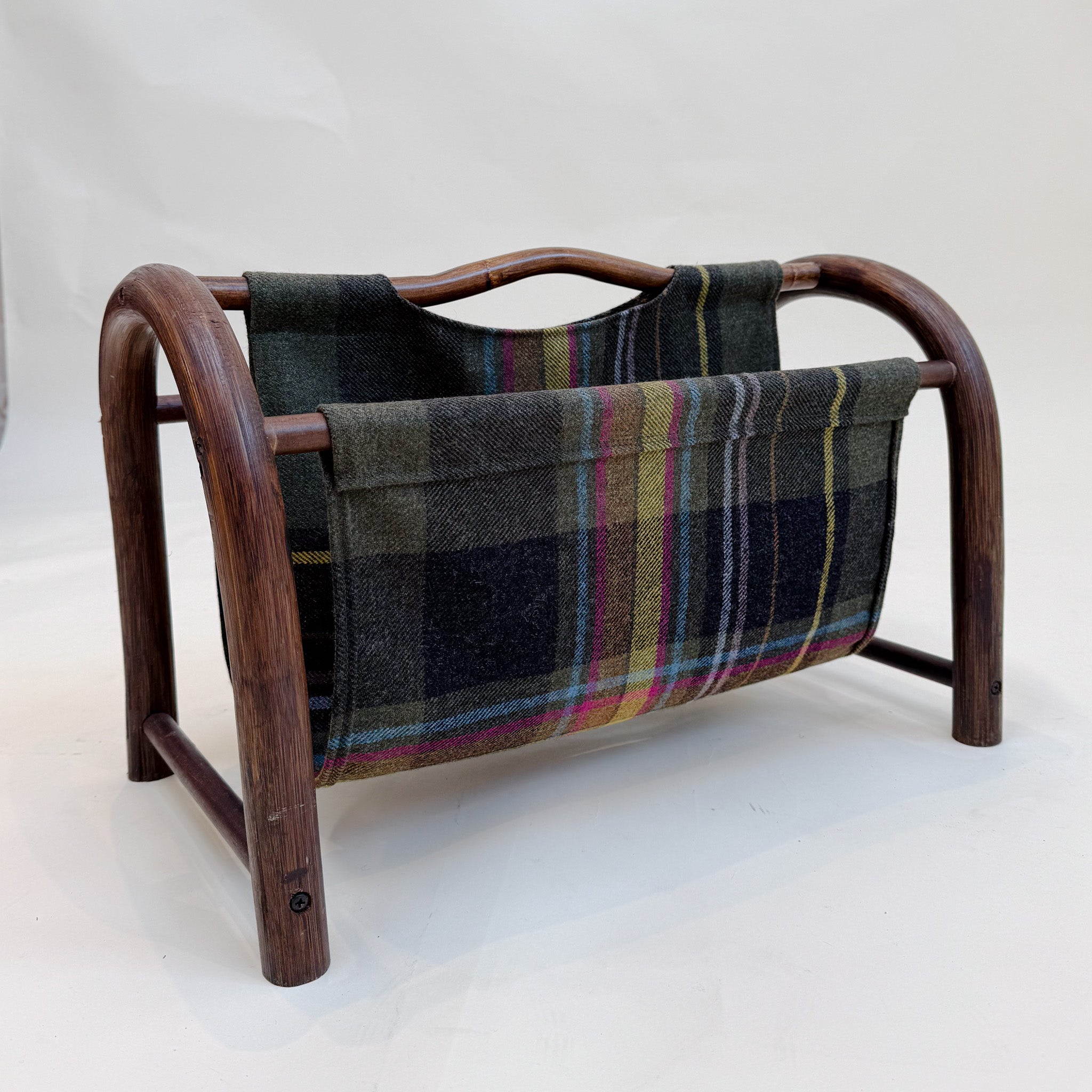 Wooden magazine rack with plaid fabric cover on a white background