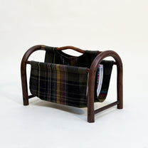 Wooden magazine rack with plaid fabric on a white background