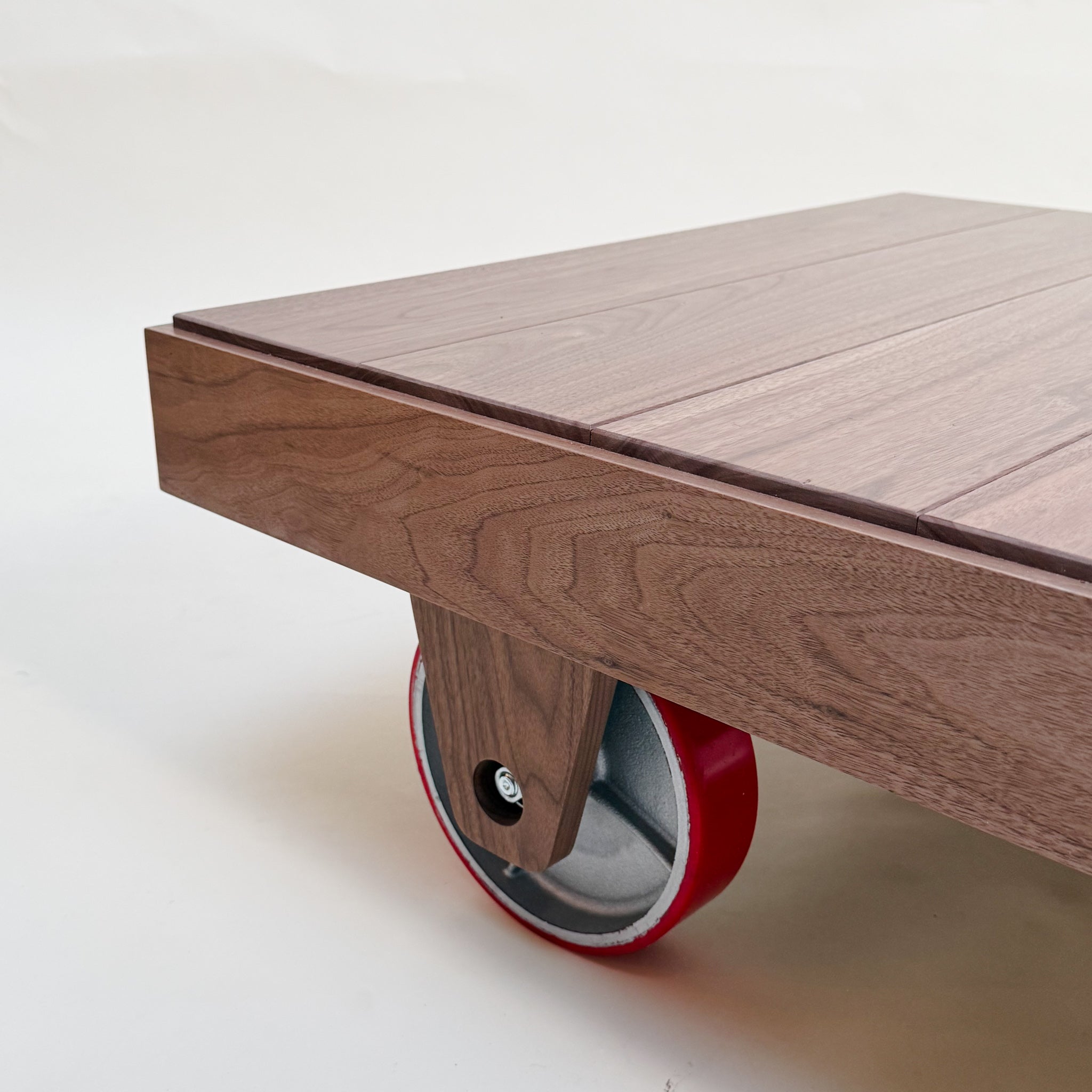 Wooden table with a red wheel on a white background